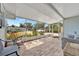 Relaxing screened-in porch with comfortable seating and views of the outdoors at 15591 Darien Way, Clearwater, FL 33764