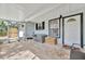 Inviting covered porch with brick floors, perfect for outdoor relaxation and entertaining at 15591 Darien Way, Clearwater, FL 33764