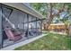 Landscaped yard with a screened porch, a backyard retreat at 15591 Darien Way, Clearwater, FL 33764