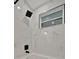 Shower with black fixtures and marbled tile at 15591 Darien Way, Clearwater, FL 33764