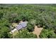 Aerial view of the home surrounded by lush mature trees showing the privacy of the lot at 16224 Iola Woods Trl, Dade City, FL 33523