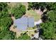 An aerial perspective showcases the home's layout and expansive wooded lot with a circular driveway at 16224 Iola Woods Trl, Dade City, FL 33523
