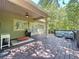 Relaxing outdoor deck space features a grill, outdoor furniture, and ceiling fan to enjoy the weather at 16224 Iola Woods Trl, Dade City, FL 33523