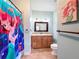 Bathroom featuring light blue walls and shower with light brown tiles at 16224 Iola Woods Trl, Dade City, FL 33523