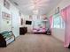 Spacious bedroom with a bed, window, chandelier, and ample closet space at 16224 Iola Woods Trl, Dade City, FL 33523