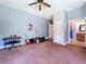 Spacious bonus room featuring plush carpeting, ceiling fan, and adjacent bathroom at 16224 Iola Woods Trl, Dade City, FL 33523