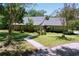 Charming single-story home with a well-manicured front yard and a welcoming pathway at 16224 Iola Woods Trl, Dade City, FL 33523