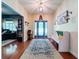 The home's entry foyer features hardwood floors, a decorative rug, and natural light at 16224 Iola Woods Trl, Dade City, FL 33523