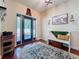 A comfortable foyer with a light blue accent rug, bench, and hardwood flooring provides a welcome to the home at 16224 Iola Woods Trl, Dade City, FL 33523