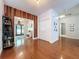 Inviting entryway with wood paneling, a closet, and views of the front door at 16224 Iola Woods Trl, Dade City, FL 33523