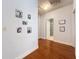 Hallway featuring hardwood floors and decorative picture frames at 16224 Iola Woods Trl, Dade City, FL 33523