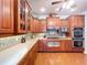 Well-appointed kitchen boasting custom wood cabinets, tiled backsplash, and modern stainless-steel appliances at 16224 Iola Woods Trl, Dade City, FL 33523