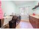 Bright laundry room with Samsung washer and dryer, utility sink, and ample countertop space at 16224 Iola Woods Trl, Dade City, FL 33523