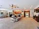 Spacious living area with hardwood floors, open kitchen, and cozy carpeted seating area, perfect for entertaining at 16224 Iola Woods Trl, Dade City, FL 33523