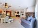 Cozy living room with a stone fireplace and comfortable seating, perfect for relaxing at 16224 Iola Woods Trl, Dade City, FL 33523