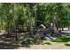 Outdoor playground features a playset with a slide, climbing structure, and a storage shed at 16224 Iola Woods Trl, Dade City, FL 33523