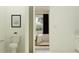 Bathroom view showcasing a toilet and a glimpse into a bedroom, blending functionality with comfortable living spaces at 16955 Falling Waters Ct, Land O Lakes, FL 34638