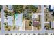 Aerial view of the property shows the layout of the land next to a luxurious home with a pool at 1905 1St St, Indian Rocks Beach, FL 33785