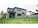 Newly built home showcasing a large backyard and gray exterior at 19314 Long Lake Ranch Blvd, Lutz, FL 33558