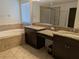 Luxurious main bathroom with double sinks, a soaking tub, and separate shower at 19314 Long Lake Ranch Blvd, Lutz, FL 33558