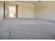 Expansive bonus room offers versatility, featuring neutral carpet and natural light, perfect for various activities at 19314 Long Lake Ranch Blvd, Lutz, FL 33558