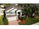 Attractive two-story home featuring well-maintained landscaping and a brick driveway, offering classic curb appeal at 19314 Long Lake Ranch Blvd, Lutz, FL 33558