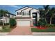 Charming two-story home featuring a brick-accented facade, well-manicured lawn, and a spacious two-car garage at 19314 Long Lake Ranch Blvd, Lutz, FL 33558