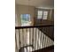 Bright foyer with a decorative glass front door and staircase with wrought iron railing at 19314 Long Lake Ranch Blvd, Lutz, FL 33558