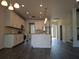 Bright kitchen features white cabinetry, stainless steel appliances, and a center island at 19314 Long Lake Ranch Blvd, Lutz, FL 33558