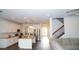 Bright, open kitchen featuring white cabinetry, stainless steel appliances, and a large island with granite countertops at 19314 Long Lake Ranch Blvd, Lutz, FL 33558