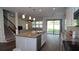 Spacious kitchen showcasing a large island, stainless steel appliances, and a seamless transition to the living area and backyard at 19314 Long Lake Ranch Blvd, Lutz, FL 33558