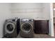 Functional laundry room with modern washer and dryer units, storage, and a utility sink at 19314 Long Lake Ranch Blvd, Lutz, FL 33558