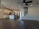 Open-concept living space boasts a modern kitchen, wood floors, and ample natural light at 19314 Long Lake Ranch Blvd, Lutz, FL 33558