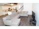 Open-concept living area showcases a large sectional sofa, seamless flow to the kitchen, and hardwood flooring at 19314 Long Lake Ranch Blvd, Lutz, FL 33558
