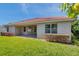 Back view of the house with tile roof, windows and patio at 2218 Valterra Vista Way, Valrico, FL 33594