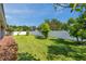 Spacious backyard features lush green grass, trees, and a privacy fence at 2218 Valterra Vista Way, Valrico, FL 33594