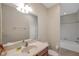 Bathroom with a single vanity, mirror and a shower-tub combo, providing essential amenities at 2218 Valterra Vista Way, Valrico, FL 33594