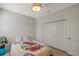 Bright bedroom with a double door closet and a decorative light fixture at 2218 Valterra Vista Way, Valrico, FL 33594