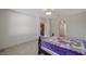 Bedroom showcasing tile floors, neutral walls, and a transom window at 2218 Valterra Vista Way, Valrico, FL 33594
