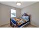 Cozy bedroom featuring a carved wood bed frame and a window for natural light at 2218 Valterra Vista Way, Valrico, FL 33594