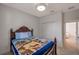 This bedroom has a beautiful wooden bed, closet, and access to the hallway at 2218 Valterra Vista Way, Valrico, FL 33594