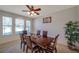 Cozy dining room with a ceiling fan and natural light from the large windows at 2218 Valterra Vista Way, Valrico, FL 33594