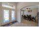 Inviting foyer featuring decorative glass doors, a tray ceiling, and an open view of the dining room at 2218 Valterra Vista Way, Valrico, FL 33594