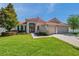 Charming single-story home featuring a red tile roof, manicured lawn, and a welcoming double-door entrance at 2218 Valterra Vista Way, Valrico, FL 33594