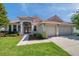 Inviting single-Gathering home with a red tile roof, an attached two-car garage, and a meticulously maintained lawn at 2218 Valterra Vista Way, Valrico, FL 33594