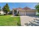 Attractive single-story home boasting a red tile roof, well-maintained lawn, and an attached two car garage at 2218 Valterra Vista Way, Valrico, FL 33594