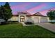 Charming single-Gathering home featuring a red tile roof, well-maintained landscaping, and an attached two-car garage at 2218 Valterra Vista Way, Valrico, FL 33594