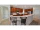 Open kitchen with stainless steel appliances, breakfast bar, and tile flooring at 2218 Valterra Vista Way, Valrico, FL 33594