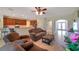 Open-concept living space with tile floors, comfortable seating, open to the kitchen and dining area, perfect for entertaining at 2218 Valterra Vista Way, Valrico, FL 33594