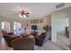 Comfortable living room featuring tile floors, a ceiling fan, and an open floor plan at 2218 Valterra Vista Way, Valrico, FL 33594